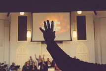 hands raised at a worship service 