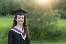 female graduate in cap and gown  