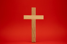 Wood cross on a red background