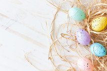 pastel Easter eggs in straw 