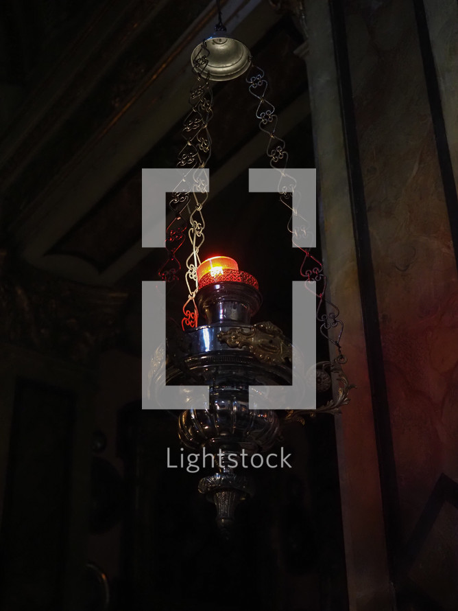 Ancient candle lantern in dark church interior