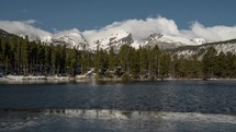 Time lapse of clouds rolling over mountain tops at Sprague Lake in Rocky Mountain National Park in Colorado.