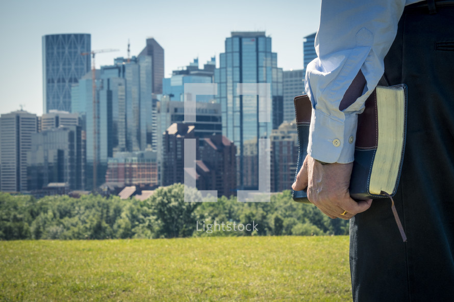 man with Bible and City Skyline 