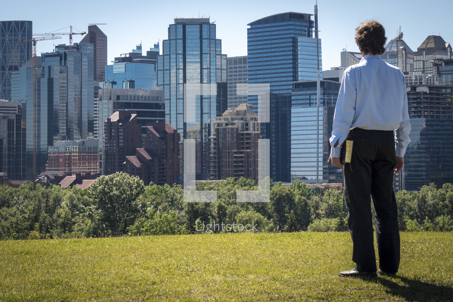 man with a Bible and City Skyline 