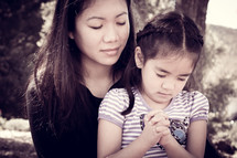 mother and daughter in prayer