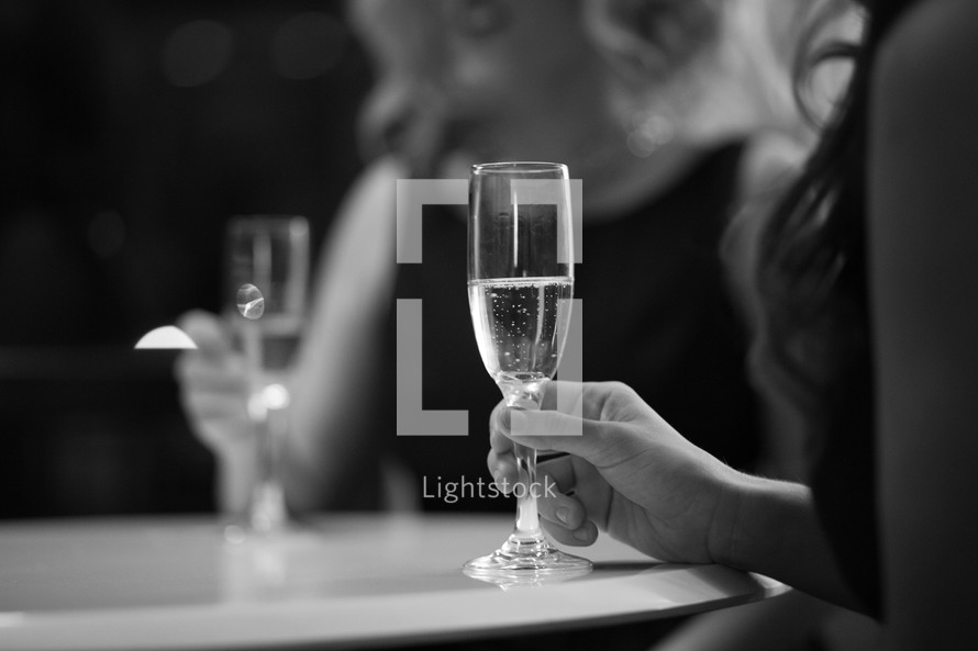 women holding champagne glasses 