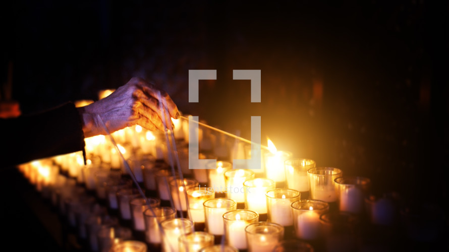 lighting prayer candles with a match 