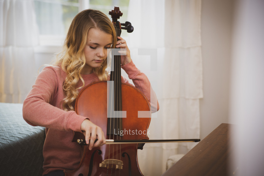 teen girl playing a cello 