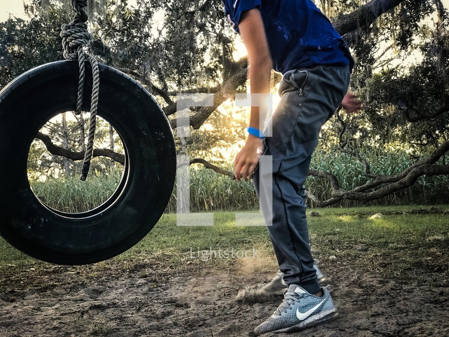 a boy and a tire swing 