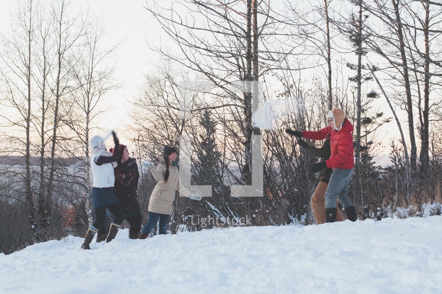 snowball fight outdoors in winter snow 