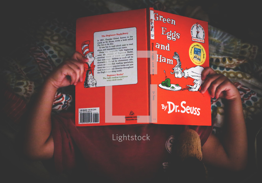 a child reading a Dr Seuss book 