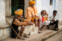 men sitting on the dusty streets of India 
