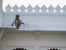 a man painting a building in India 