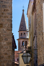 View of the Saint Ivan church bell tower from the narrow streets of Old Town Budva, Montenegro