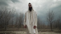 Jesus Christ in white tunic in Jerusalem wilderness fasting for 40 days and 40 nights being tempted by Satan.