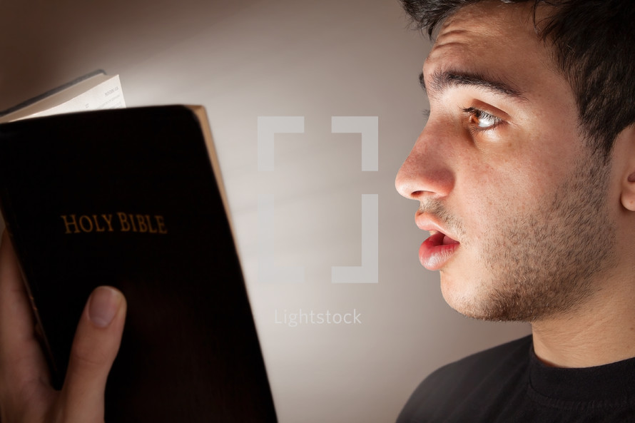 man reading the Bible in amazement 
