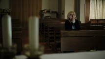 woman praying alone in a church 