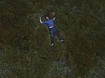 a man laying in moss 