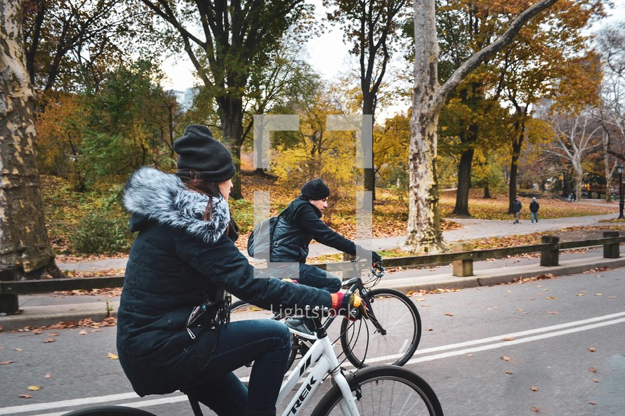 couple riding bikes in a park 