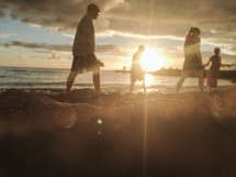 people walking on a beach at sunset in Hawaii 