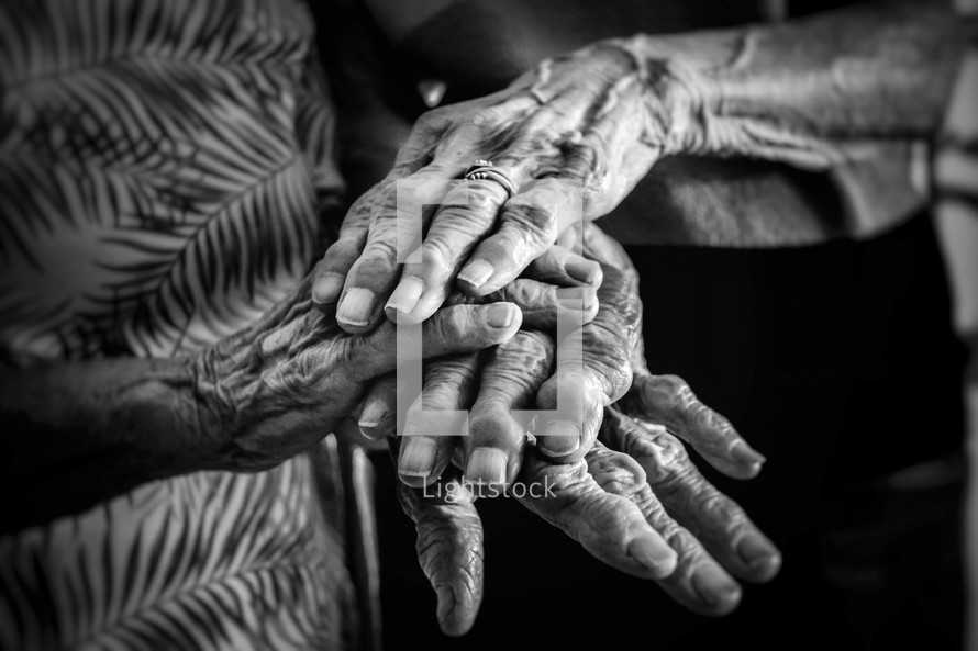 elderly couple holding hands 