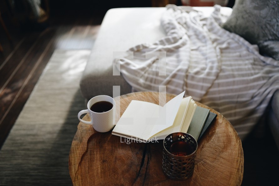 coffee and journal on a side table 