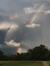 rainbow through a grey cloud 