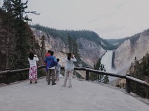 people at a viewing station overlooking a waterfall 