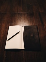 pen on an open journal 