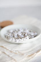 Close-up of white beads that spell out "blessed."