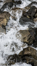 Close-up of rocks in the river water flowing down