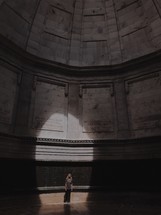 a woman standing under a dome 