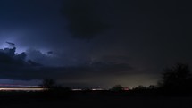 Timelapse of a monsoon thunderstorm over a highway at night