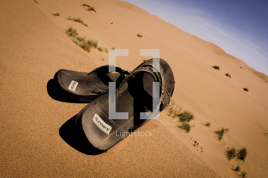 flip flops in desert sands 