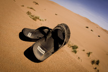 flip flops in desert sands 