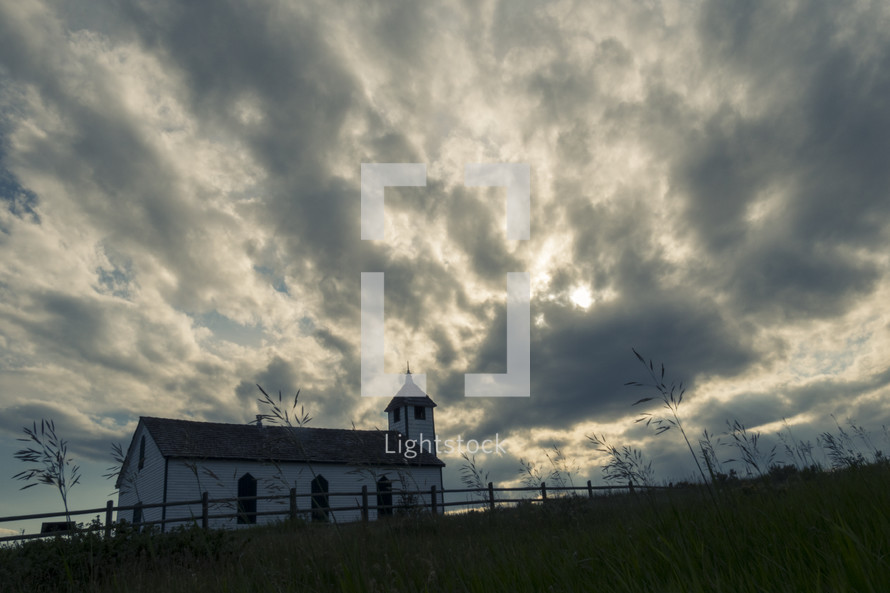 Small country church under dark cloudy sky