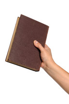A hand holding a Bible.