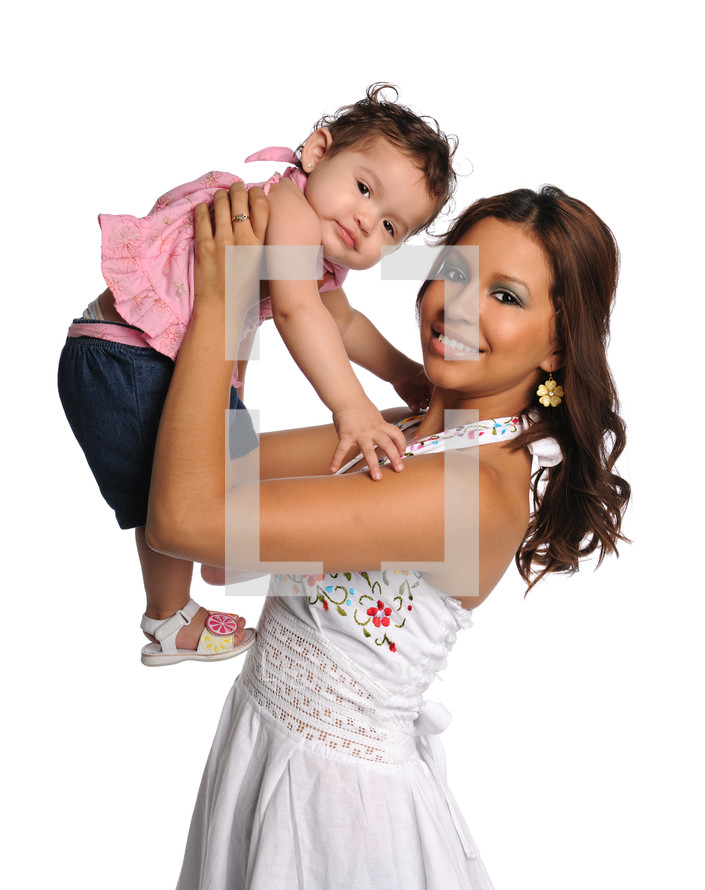 woman holding a baby girl over her head