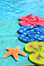 flip flops and star fish on a blue background 