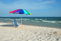 umbrella and chair on a beach 