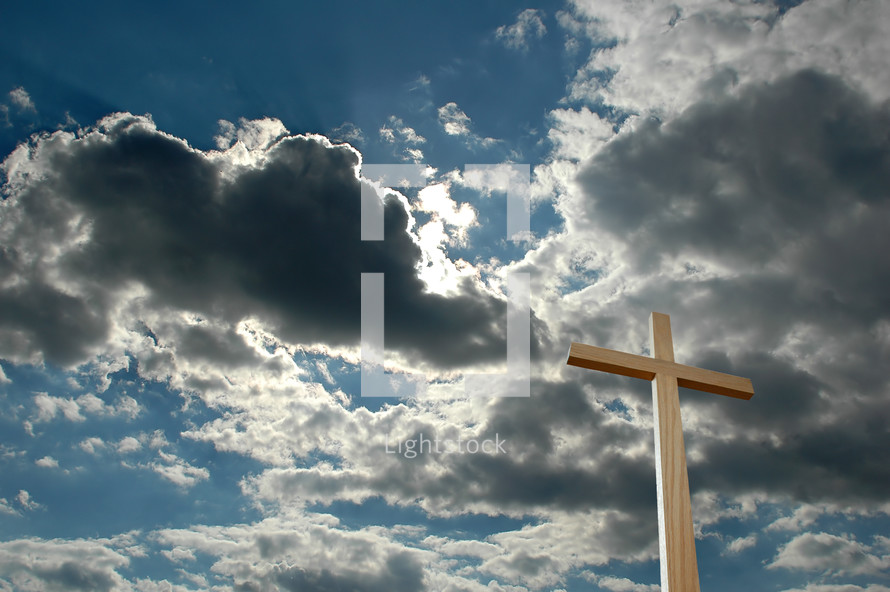 blue sky and clouds and a wood cross 