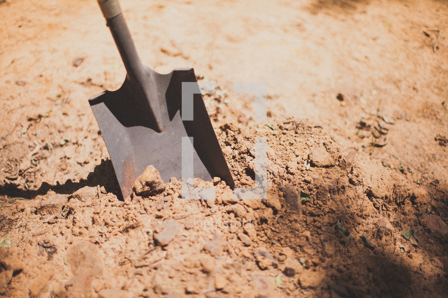digging a hole with a shovel