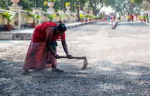 a woman cleaning the streets of India 