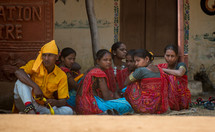 girls and women sitting together on the streets of India 