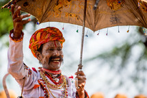 a man with painted face and turban in India 