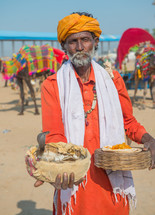 a snake charmer in India with a cobra 