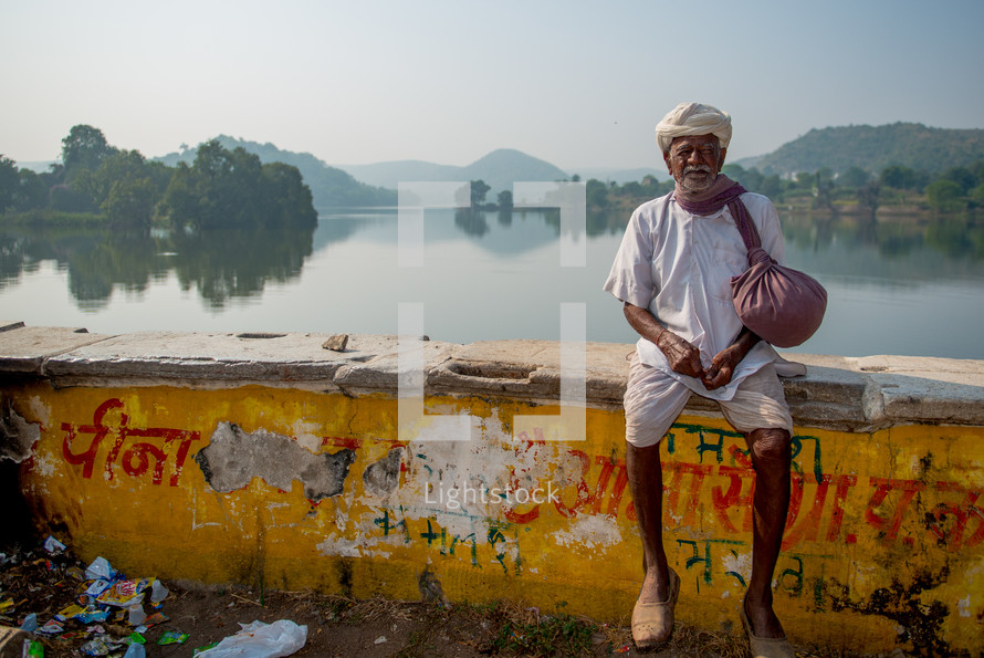 a man sitting on a bridge in India 