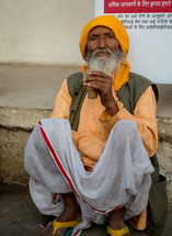a man sitting on a curb in India 