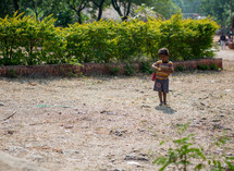 boy playing with a toy car in India 