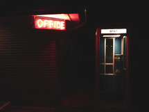 glowing office sign and telephone booth 